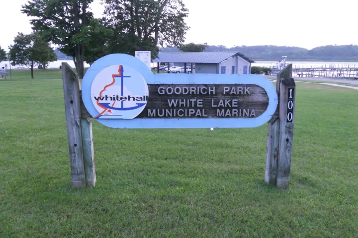 a sign on a grassy field