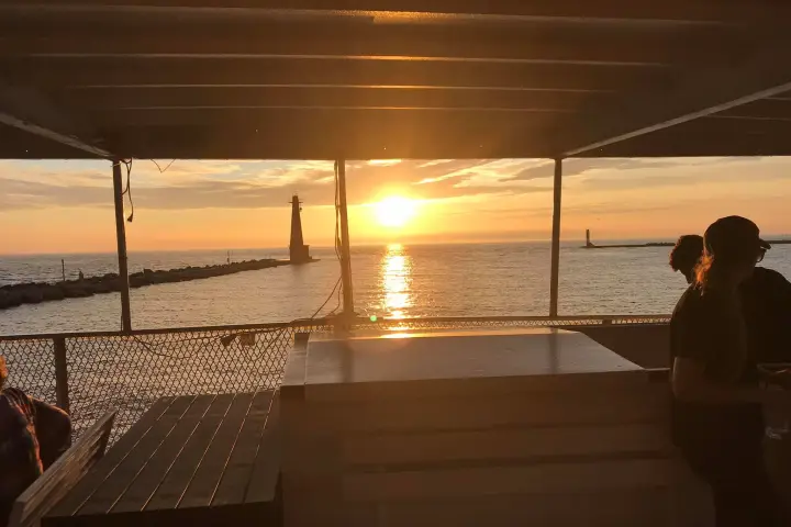 a couple of people on a beach near a body of water