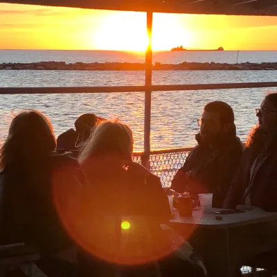 a group of people standing in front of a body of water