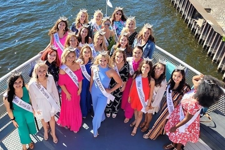 a group of people standing next to a body of water